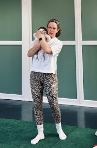 Postnatal Pilates instructor teaching a new mum with her baby in a supportive class environment in Epping